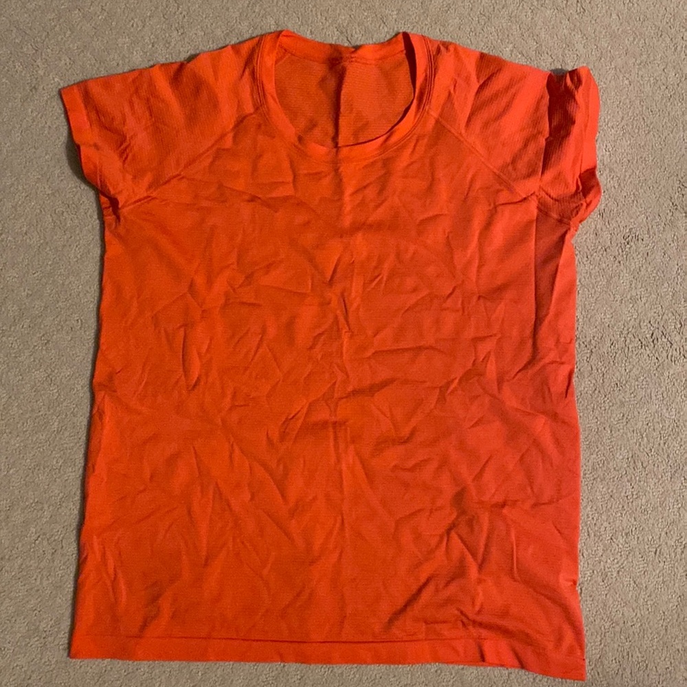 Anti-stink Lululemon top is made for training and running! Bright Orange color.